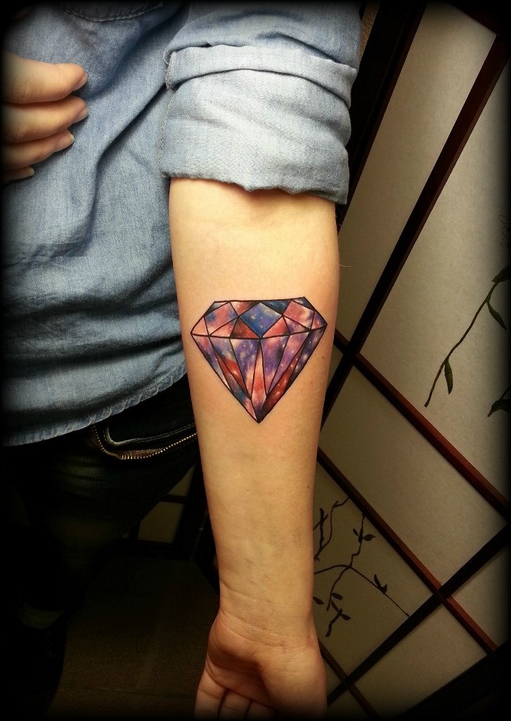 Colored diamond tattoo on forearm for women