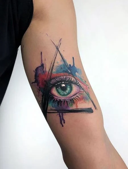 Colorful eye tattoo on shoulder for women