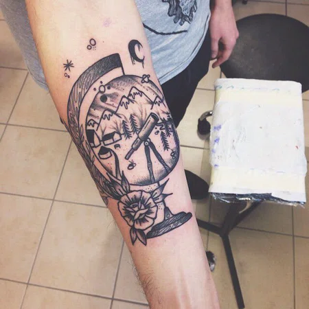 Globe tattoo on forearm for men