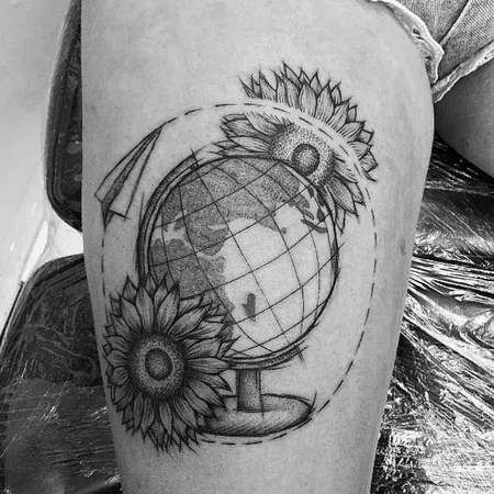 Globe tattoo on thigh for women