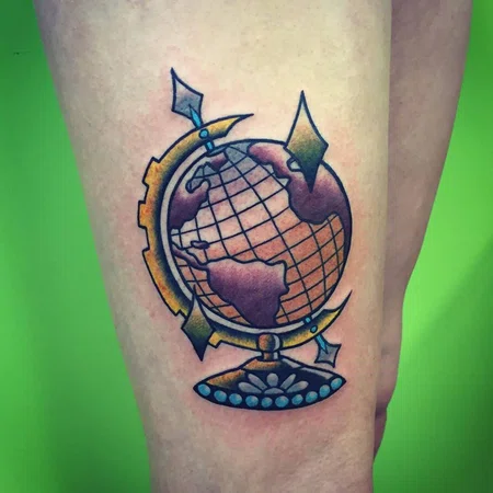 Color globe tattoo on thigh for men