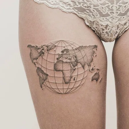 Globe tattoo on thigh for women