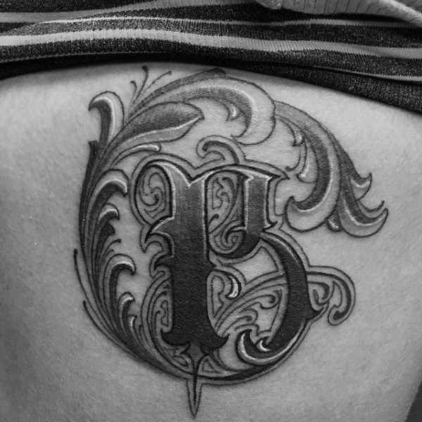 Lettering style tattoo on the stomach for men