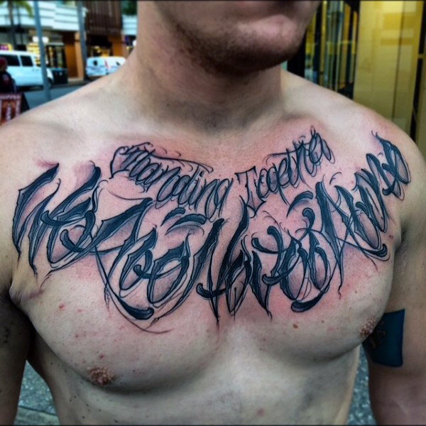 Lettering style tattoo on the chest for men