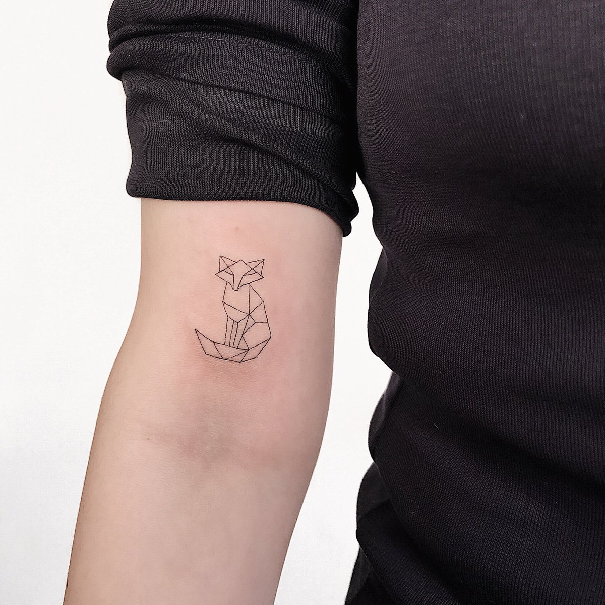 Minimalist fox tattoo on the shoulder for women