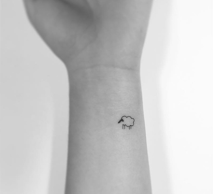 Minimalist tattoo on the arm for women