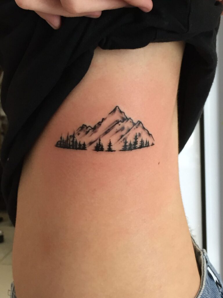 Mountain tattoo on the side for women