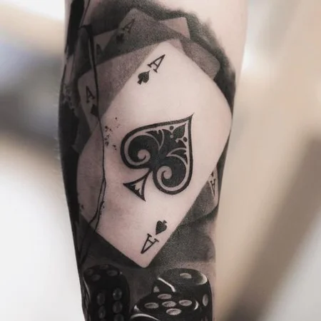 Tattoo of playing cards on the arm for men