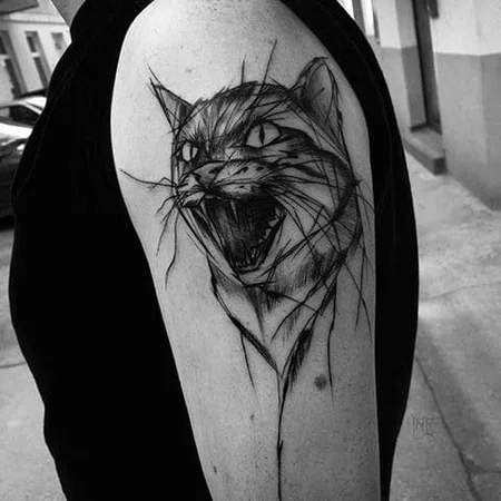 Sketch style cat tattoo on shoulder for men