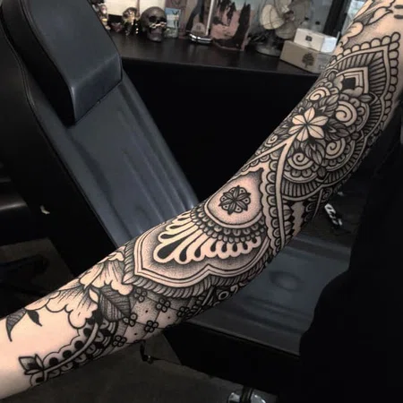 Ornamental style tattoo on the arm for women