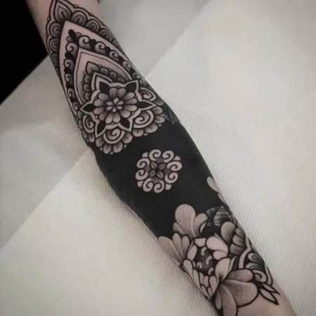 Ornamental style tattoo on the arm for women