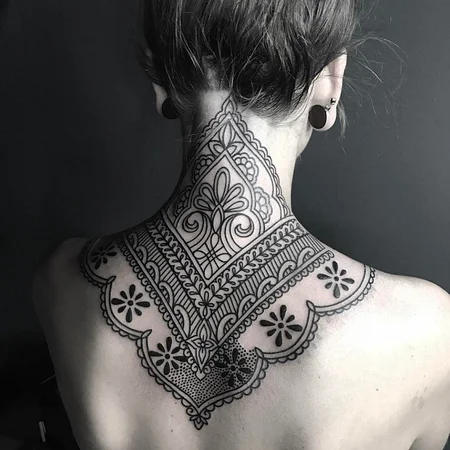 Ornamental style tattoo on the back of the head for women