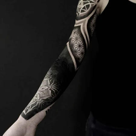 Ornamental style tattoo on the arm for men