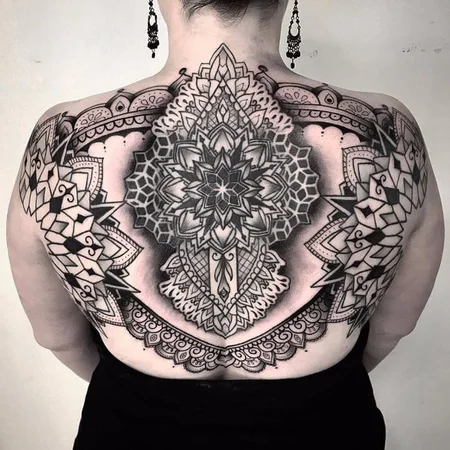 Ornamental style tattoo on the back for women