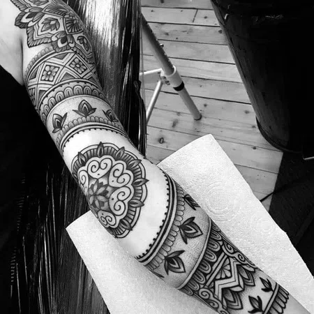 Ornamental style tattoo on the arm for women