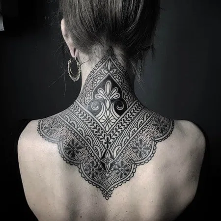 Ornamental style tattoo on the back of the head for women