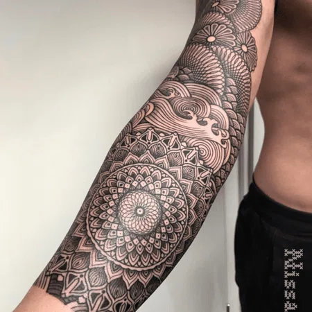 Ornamental style tattoo on the arm for men