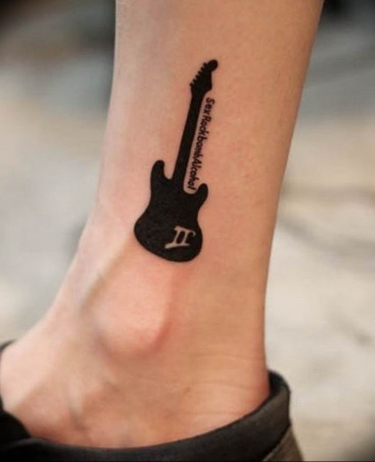 Guitar tattoo on shin for men