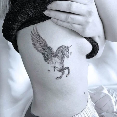 Unicorn tattoo on the side for women