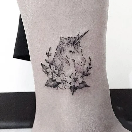 Unicorn tattoo on shin for women