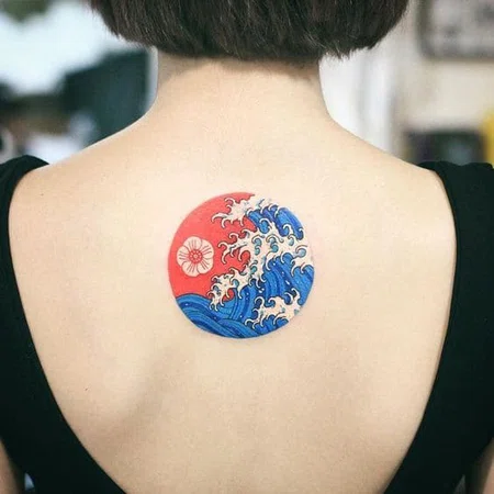 Wave tattoo on the back for women