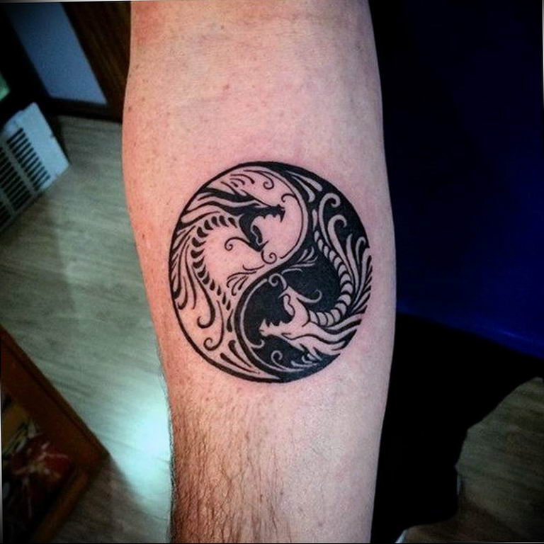 Yin-yang tattoo on forearm for men