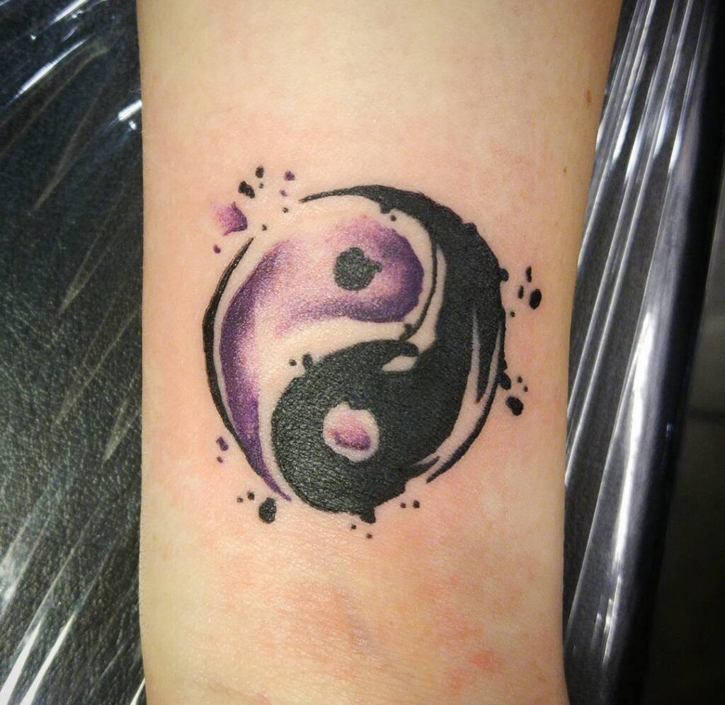 Yin-yang tattoo on the arm for men