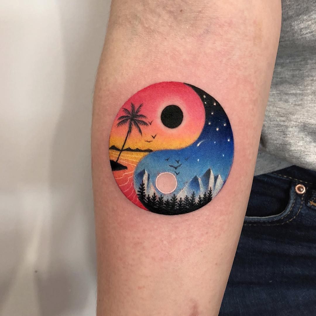 Colorful yin-yang tattoo on forearm for men