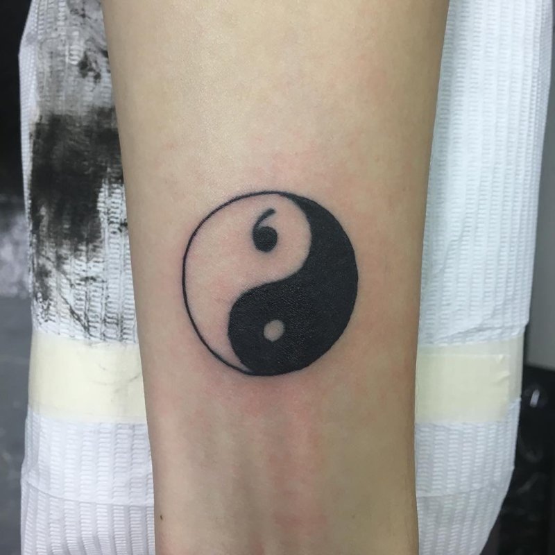 Yin-yang tattoo on forearm for men