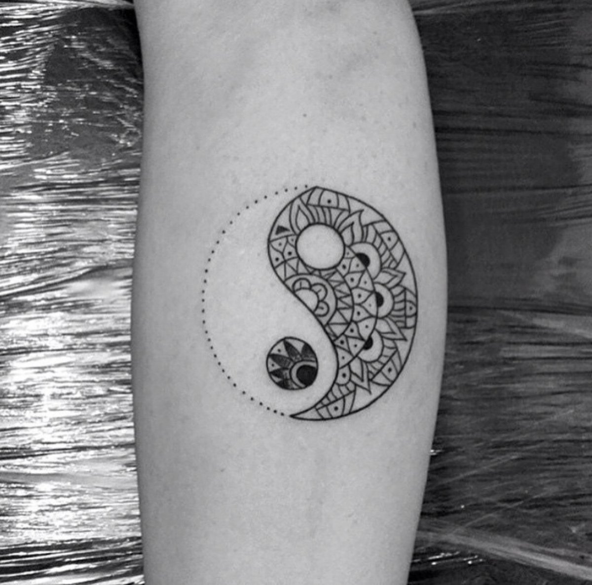 Yin-yang tattoo on forearm for women