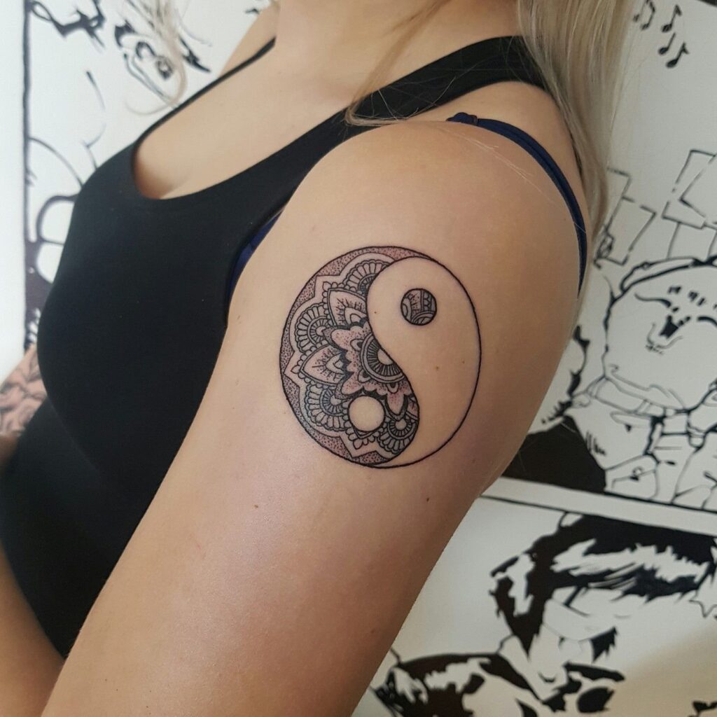 Yin-yang tattoo on the shoulder for women