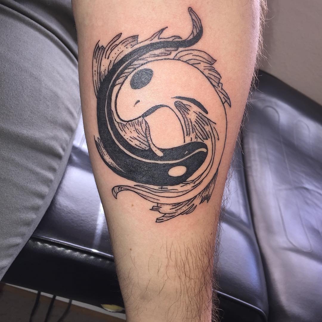 Yin-yang tattoo on the arm for men