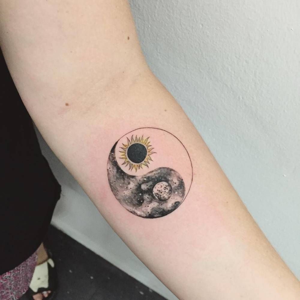 Yin-yang tattoo on forearm for women