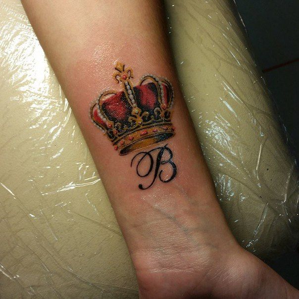 Crown tattoo on forearm for men