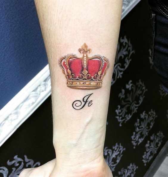 Crown tattoo on forearm for men