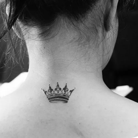 Small crown tattoo on neck for women