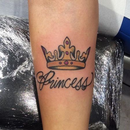 Crown tattoo with inscription on the arm for men