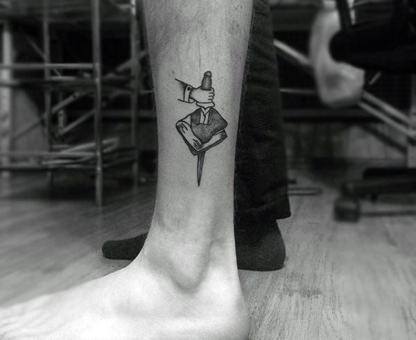 Book tattoo on the shin for men