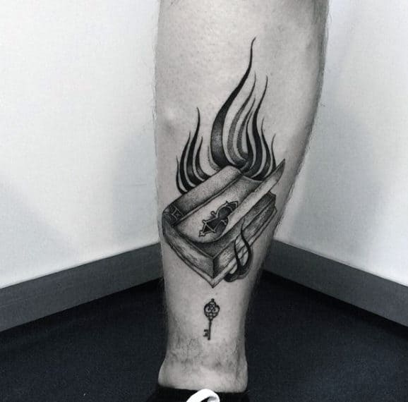 Book tattoo on leg for men