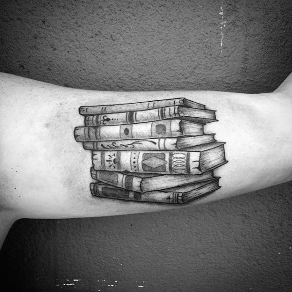 Book tattoo on the arm for men