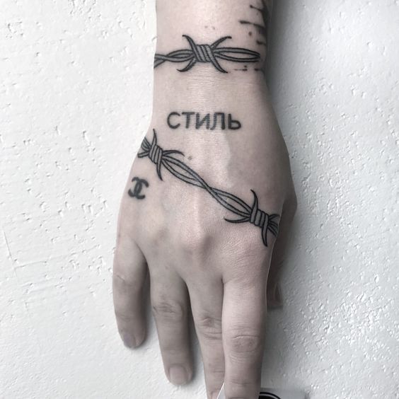 Barbed wire tattoo on hand for women