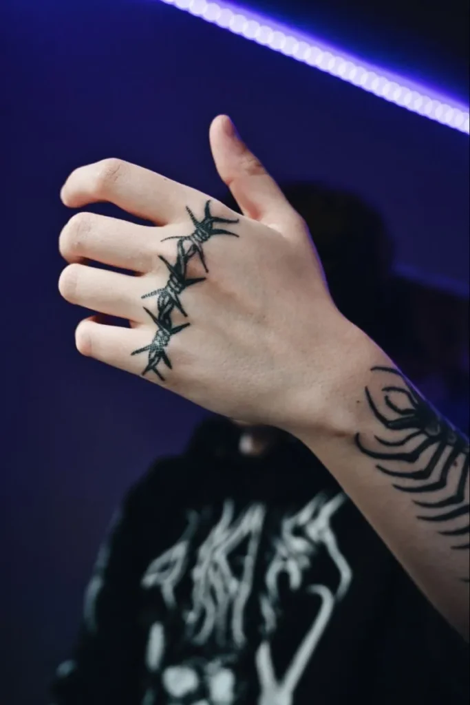 Barbed wire tattoo on hand for men