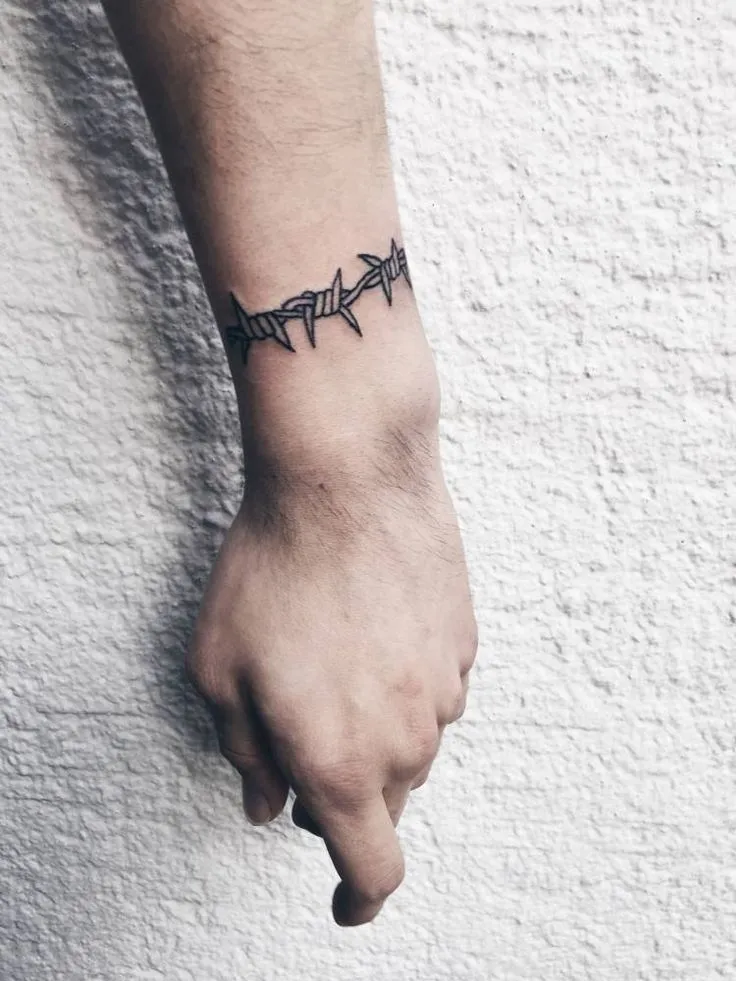 Barbed wire tattoo on forearm for men