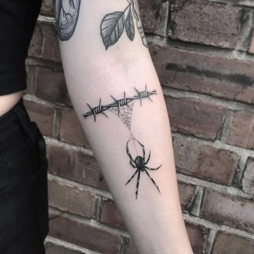 Barbed wire tattoo on forearm for women