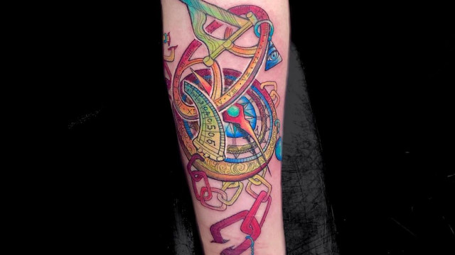 Colorful compass tattoo on the arm for men