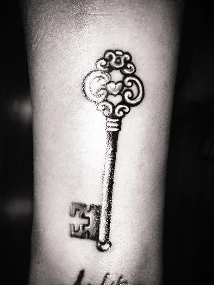 Key tattoo on the arm for men