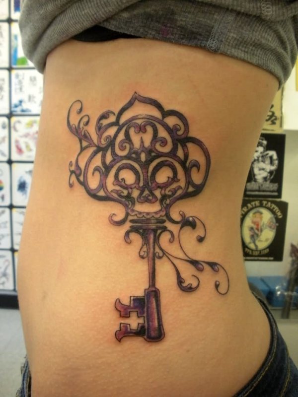 Large key tattoo on the side for women