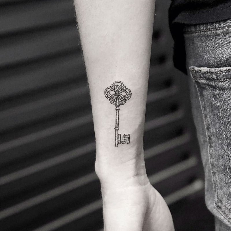 Key tattoo on the arm for men