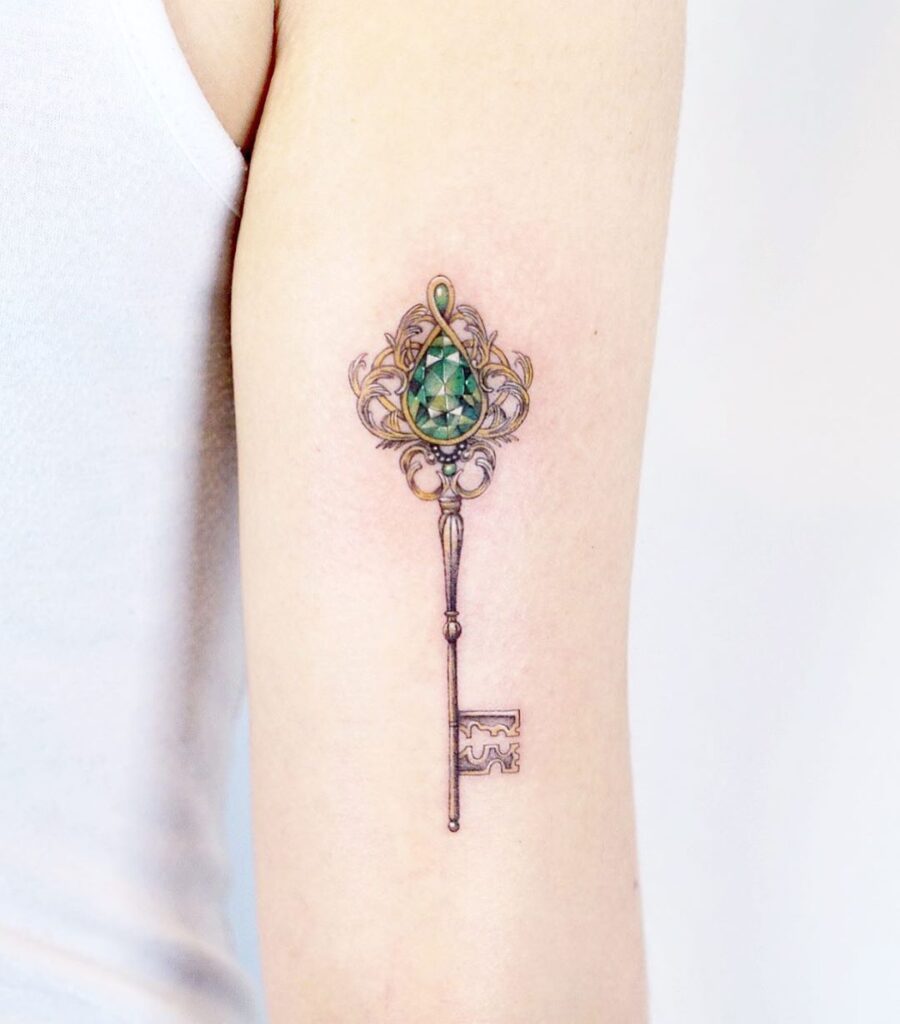 Key tattoo on the shoulder for women