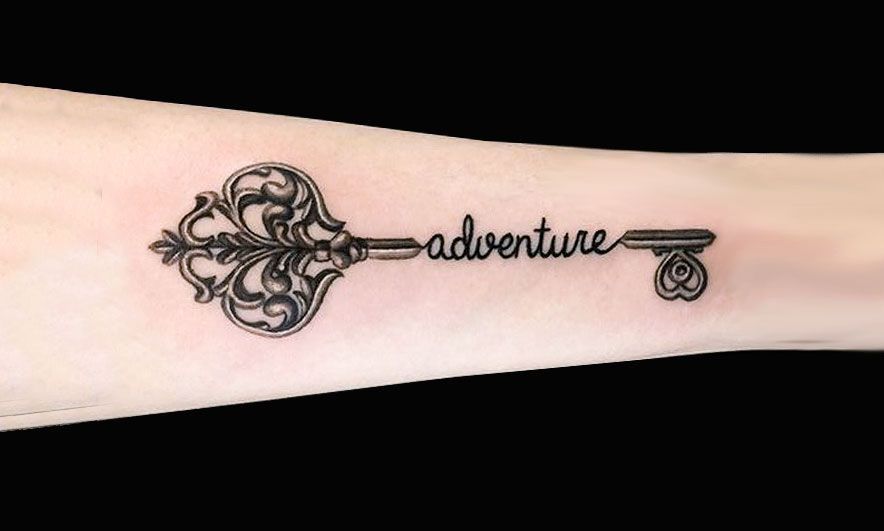 Key tattoo with inscription on the arm for men